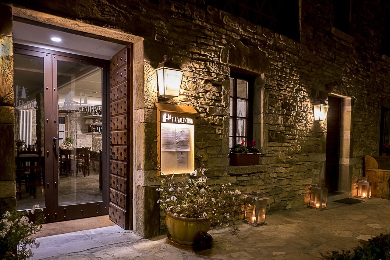 L’ingresso in pietra dell’Osteria Zia Valentina illuminato dalle lanterne